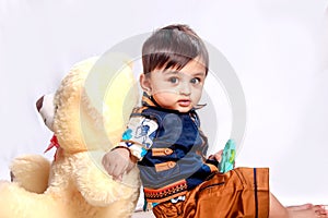 Cute Indian baby child playing with toy