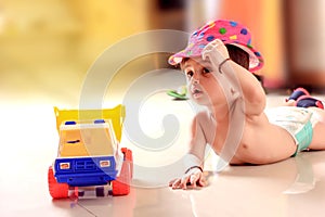 Cute Indian baby child playing with toy