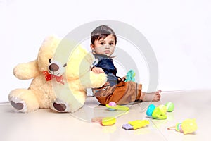 Cute Indian baby child playing with toy