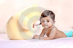 Cute Indian baby child playing with toy