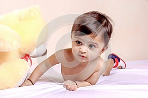 Cute Indian baby child playing with toy