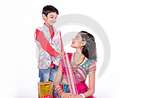 Cute Indian brother and sister celebrating raksha bandhan festival ,