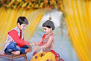 Cute Indian child brother and sister celebrating raksha bandhan festival