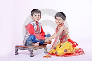 Cute Indian child brother and sister celebrating raksha bandhan festival ,