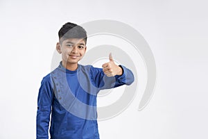 Cute indian little boy showing thumps up