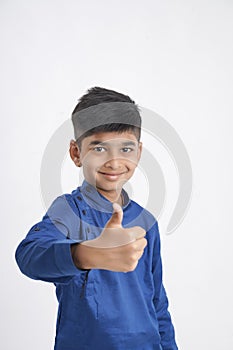 Cute indian little boy showing thumps up