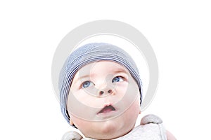 Cute inquisitive baby in a hat. Pensive little boy looking up