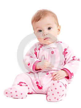 Cute isolated baby girl in pink sitting