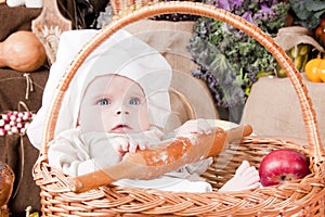 Cute kid as a chef sitting in a basket