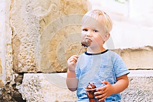 Child boy with Fritule - Croatian sweet pastry, cookies, homemade fritters