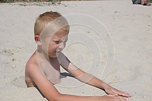 Cute kid burried in the sand