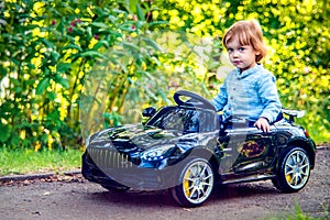 Carino un bambino ragazzo passeggiata sul elettrico auto 