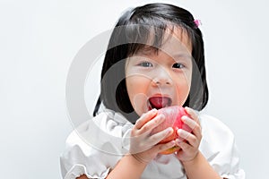 Cute kid eating red apple. Little beautiful child playing and biting an fresh fruit. Isolated on white background