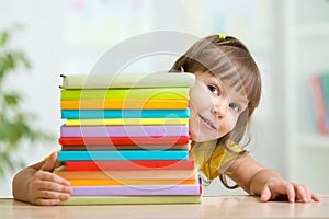 Cute kid girl preschooler with books