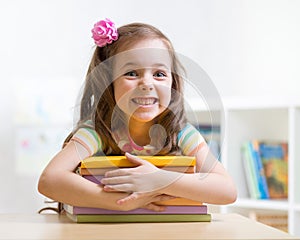 Cute kid girl preschooler with books