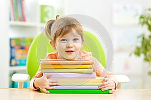Cute kid girl preschooler with books