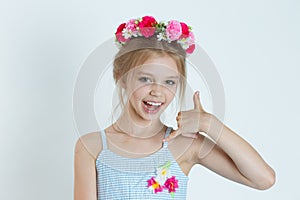Cute kid girl showing call me fingers hand sign gesture
