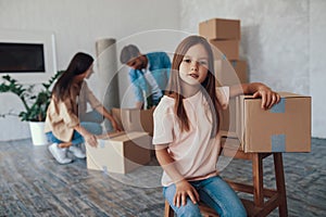 Cute kid and her parents busy making home at new place