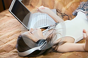 Cute kid listening to music on headphones