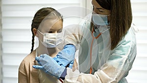 Cute kid patient visiting female doctor pediatrician nurse holding stethoscope examining happy little child girl doing