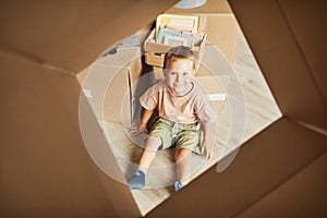 Cute Kid Playing with Box in New Home