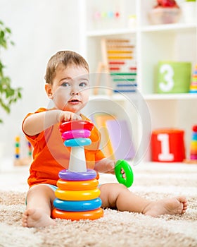 Cute kid playing with color toy indoor