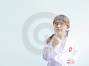 Cute kid playing doctor and thinking