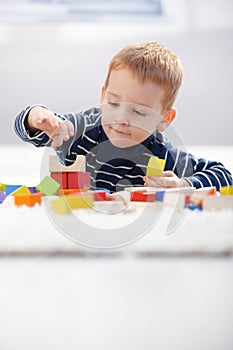 Cute kid playing on floor at home