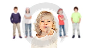 Cute kid pointing with his finger with other children background