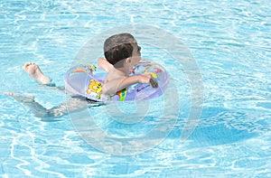 Cute kid swimming in pool