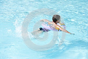 Cute kid swimming in pool