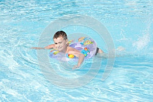 Cute kid swimming in pool