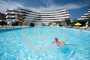 Cute kid swimming in pool