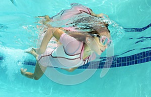 Cute kid swimming in pool