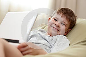 Cute kid using laptop computer smiling