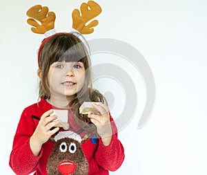 Cute kid wears in Christmas clothes and opening gift box. Christmas gifts and Christmas presents concept