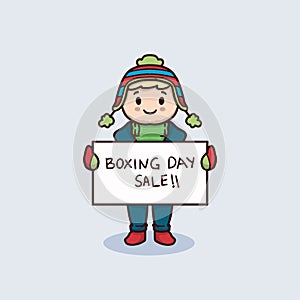 Cute kid with winter clothing holding boxing day sale banner