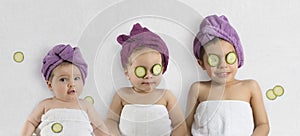Cute kids with bath turbans and cucumbers
