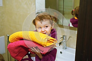 Cute kids in bathrobes in the bathroom