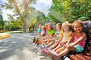 Cute kids on the bench in park toggether