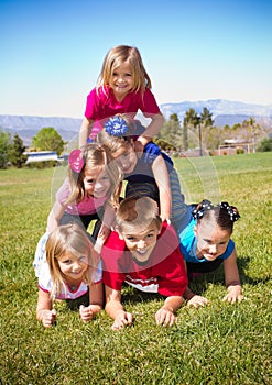 Cute Kids Building a Human Pyramid