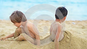 Cute Kids Buried in Sand