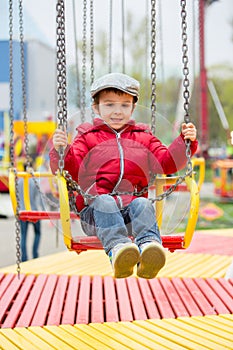 Cute kids on a chain swing carousel