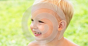 Cute kids face. Closeup portrait of smiling child boy on green background. Kid smile. Emotion concept.