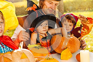 Cute kids and father in Halloween costumes