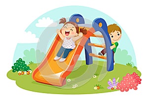 Cute kids having fun on slide in playground