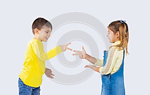 Cute kids play stone, paper scissors and have fun on a white background.