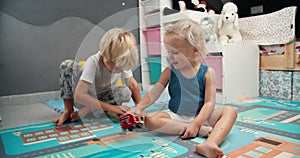 Cute Kids playing with fire tuck toys in children's room on evening