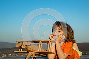 Cute kids playing with toy plane. Child dreaming.