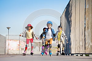 Cute kids on roller skates riding outdoors photo